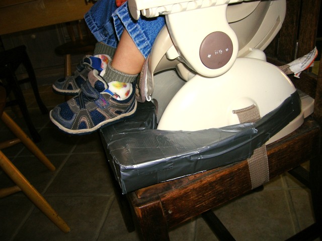 Homemade foot rest on Raphael's high chair