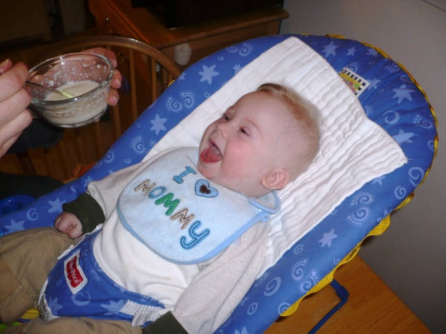 Raphael's first solid food, resting in a bouncy seat